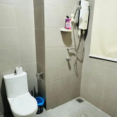 a bathroom with a shower with a toilet and a phone at Lux Retreat Home At Mercu Summer in Kuala Lumpur