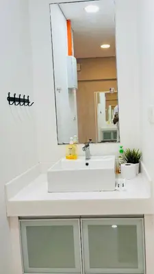 a bathroom with a white sink and a mirror at Lux Retreat Home At Mercu Summer in Kuala Lumpur
