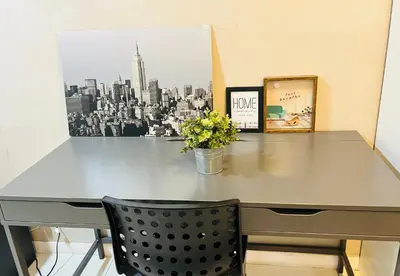 a gray desk with a picture of a city at Lux Retreat Home At Mercu Summer in Kuala Lumpur