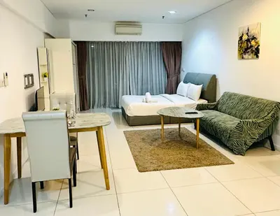 a living room with a couch and a bed at Lux Retreat Home At Mercu Summer in Kuala Lumpur