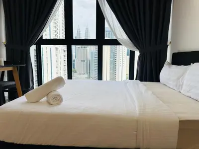 a bedroom with a large bed with a large window at Majestic Suites klcc By EQ in Kuala Lumpur