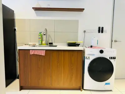 a kitchen with a washing machine and a sink at Majestic Suites klcc By EQ in Kuala Lumpur