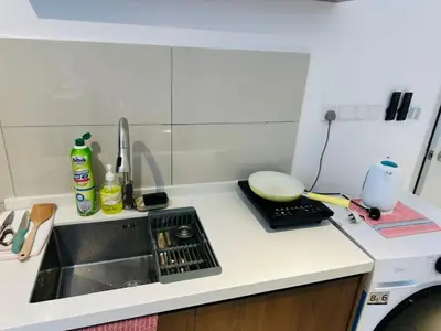 a small kitchen with a sink and a counter top at Majestic Suites klcc By EQ in Kuala Lumpur