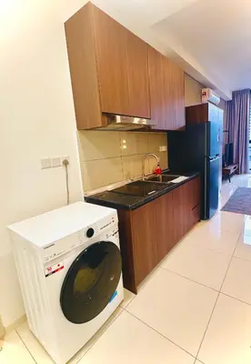 a kitchen with a washing machine and a sink at Grand Suites KLCC By Majestic Residence in Kuala Lumpur