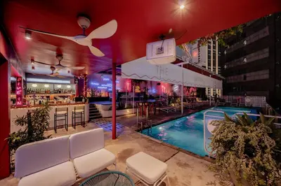 a pool at a hotel with chairs and a bar at The Kuala Lumpur Journal Hotel in Kuala Lumpur
