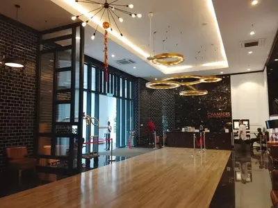 a restaurant with a large wooden counter in a room at Chamber Klcc Suites Luxury Home in Kuala Lumpur