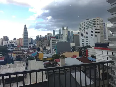 a view of a city from the balcony of a building at Chamber Klcc Suites Luxury Home in Kuala Lumpur