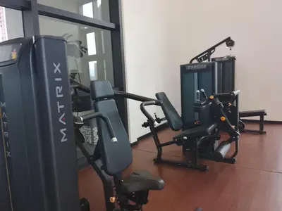 a gym with two treadmills and tread machines at Chamber Klcc Suites Luxury Home in Kuala Lumpur
