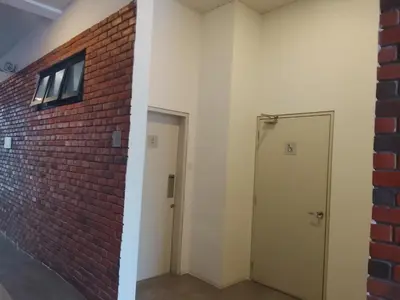 an empty room with a brick wall and a door at Chamber Klcc Suites Luxury Home in Kuala Lumpur