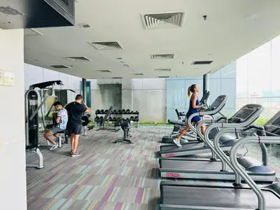 a group of people exercising on treadmills in a gym at Elegant Home at Mercu Summer Suites By KLCC in Kuala Lumpur