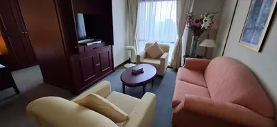 a living room with two chairs and a couch and a table at Kuala Lumpur Service suite times square s in Kuala Lumpur