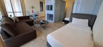 a living room with a bed and a couch at Kuala Lumpur Service suite times square s in Kuala Lumpur