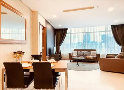 a living room with a table and a couch at Vortex Klcc By welcomes in Kuala Lumpur