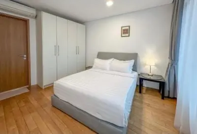 a bedroom with a large white bed and a table at Vortex Klcc By welcomes in Kuala Lumpur