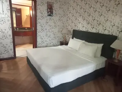 a bedroom with a large bed with white sheets at RKSON SUITE At KL in Kuala Lumpur