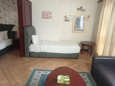 a bedroom with a bed and a table and a couch at RKSON SUITE At KL in Kuala Lumpur