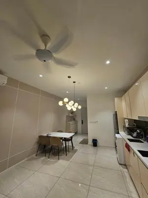 a kitchen with a table and a ceiling fan at Presidential Suite Quill Residence KLCC in Kuala Lumpur