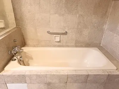 a white bath tub in a bathroom with a tile floor at Berjaya Times Square KLCC by cozy stay in Kuala Lumpur