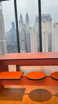 a room with a view of a city skyline at Majestic Suites KLCC by Aman Tokyo in Kuala Lumpur