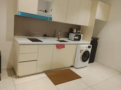 a kitchen with a sink and a washing machine at Quill Residence King House in Kuala Lumpur