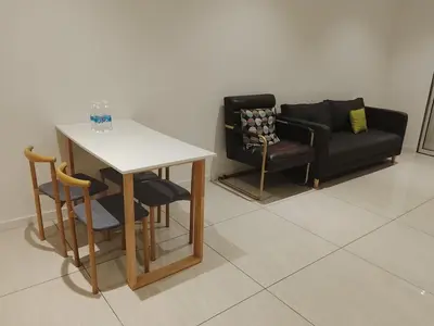 a living room with a couch and a table and chairs at Quill Residence King House in Kuala Lumpur