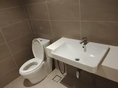 a bathroom with a white toilet and a sink at Quill Residence King House in Kuala Lumpur