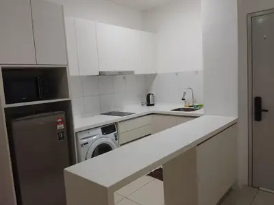a white kitchen with a sink and a dishwasher at Mix Home At Chamber Residence in Kuala Lumpur
