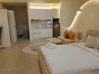 a bedroom with a bed and a living room at Mix Home At Chamber Residence in Kuala Lumpur
