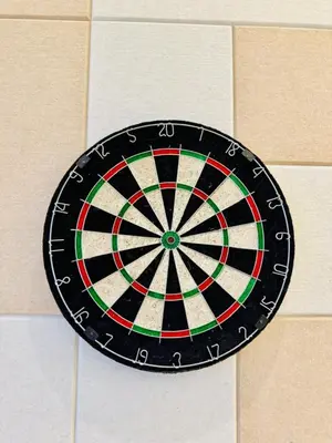 a dart board hanging on a wall at Agile Residence By Infinity Pool in Kuala Lumpur