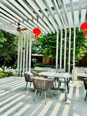 a patio with a table and chairs and red lanterns at Agile Residence By Infinity Pool in Kuala Lumpur