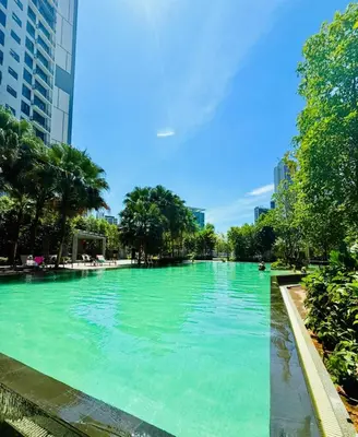 a large pool of blue water in a city at Agile Residence By Infinity Pool in Kuala Lumpur