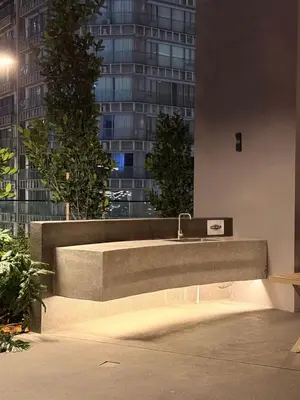 a sink in the side of a building at night at Axon KL Infinity Pool Suites near Pavilion in Kuala Lumpur