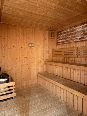 an empty sauna with wooden walls and wooden floors at Axon KL Infinity Pool Suites near Pavilion in Kuala Lumpur