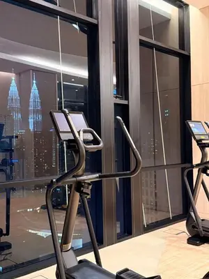 a gym with two exercise bikes in front of a window at Axon KL Infinity Pool Suites near Pavilion in Kuala Lumpur