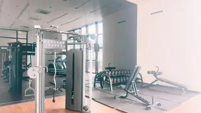 a gym with chairs and machines in a room at Chambers Residence Specious Suites KlCC in Kuala Lumpur