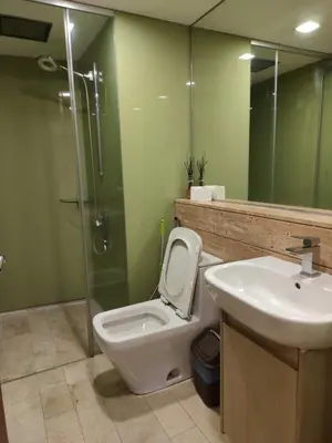 a bathroom with a toilet and a sink and a shower at Vortex Suite Klcc By Sky Moon in Kuala Lumpur