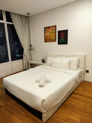 a large white bed in a room with a window at Vortex Suite Klcc By Sky Moon in Kuala Lumpur