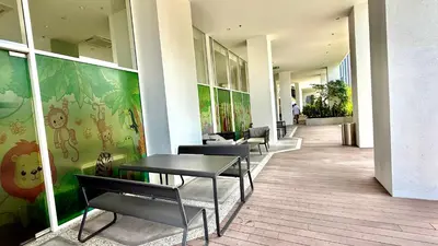 a hallway with tables and chairs in a building at Kuala Lumpur Quill Residences By AR Stay in Kuala Lumpur