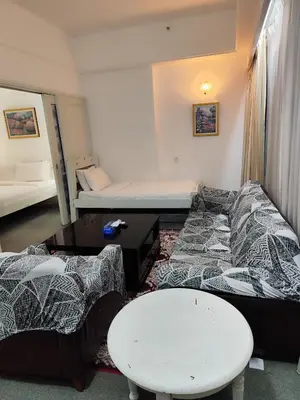 a room with a couch and a bed and a table at Moonlight Apartment service at Times Square kl in Kuala Lumpur
