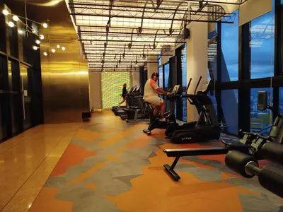 a person exercising on a treadmill in a gym at Scarletz suites Klcc by Sunlight in Kuala Lumpur