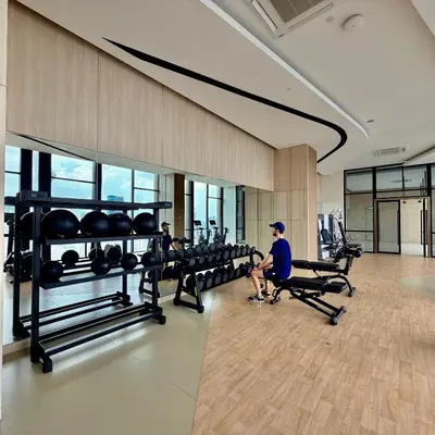 a gym with rows of treadmills and weights at Infinity pool luxury Apartment Axon in Kuala Lumpur
