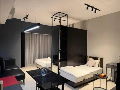 a living room with two beds and a table at Infinity pool luxury Apartment Axon in Kuala Lumpur