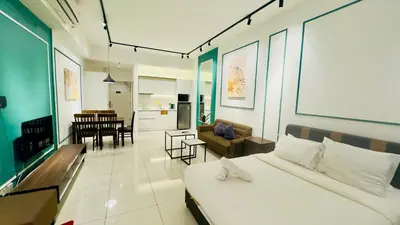 a bedroom with a bed and a living room at Chamber Residence KlCC by Royal Empire in Kuala Lumpur
