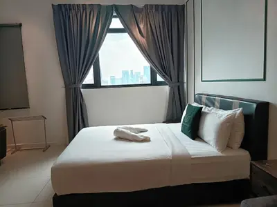 a bedroom with a large bed with a window at Chamber Residence KlCC by Royal Empire in Kuala Lumpur