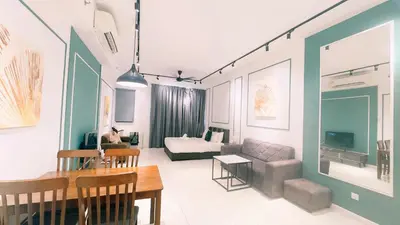 a living room with a couch and a table at Chamber Residence KlCC by Royal Empire in Kuala Lumpur