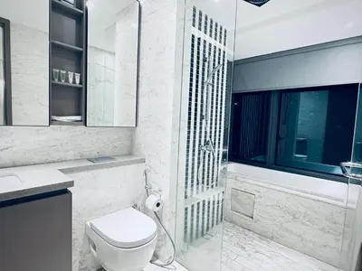 a bathroom with a toilet and a glass shower at Eaton Residences By Tropika KLCC in Kuala Lumpur