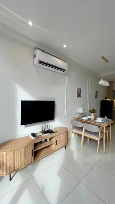 a living room with a flat screen tv and a table at Majestic Premium Residence Suites KLCC by Alaman in Kuala Lumpur