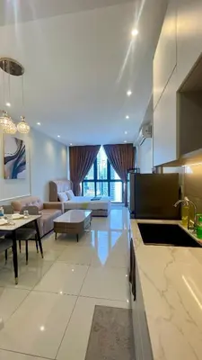 a kitchen and living room with a couch and a table at Majestic Premium Residence Suites KLCC by Alaman in Kuala Lumpur