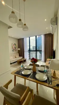 a living room with a table with chairs and a couch at Majestic Premium Residence Suites KLCC by Alaman in Kuala Lumpur