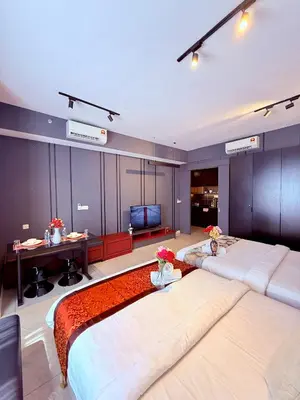a hotel room with two beds and a television at Luxury Dream Home At Axon Residence Bukit Bintang Klcc pavilion in Kuala Lumpur